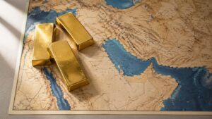 Three gold bars resting on a vintage relief map showing the Middle East, Persian Gulf, and Strait of Hormuz