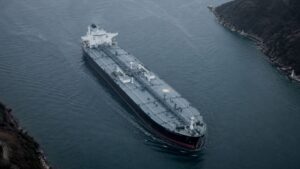 Oil tanker navigating a narrow strait, aerial view