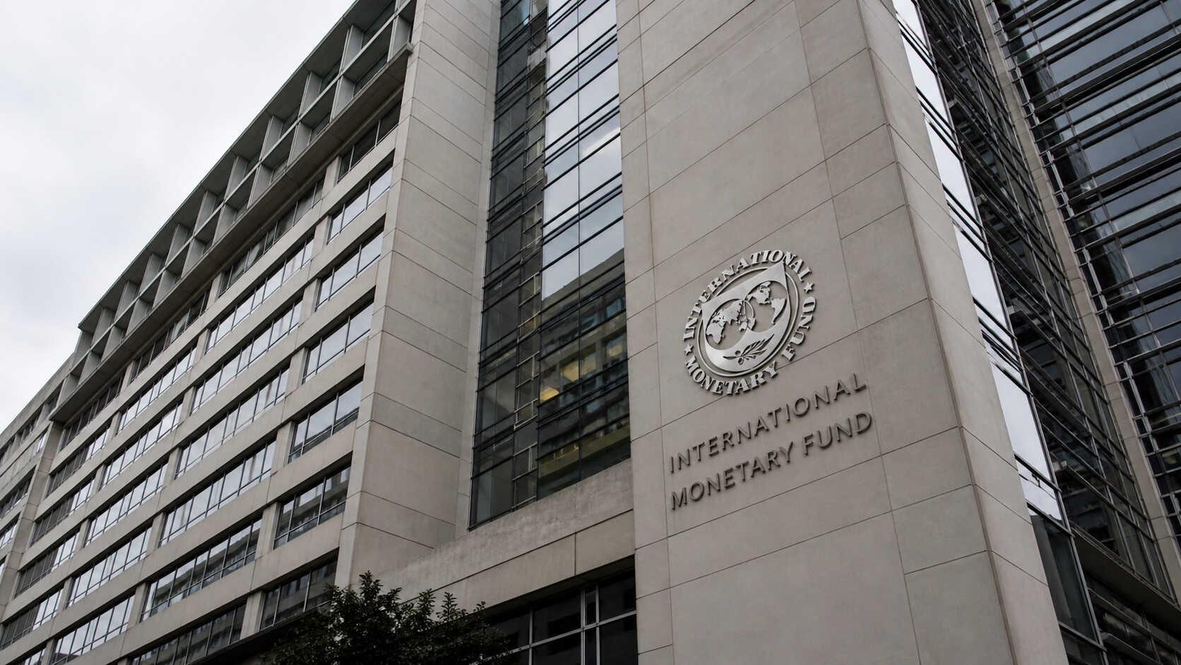 IMF headquarters building in Washington D.C. showing the International Monetary Fund logo and name on the exterior facade.