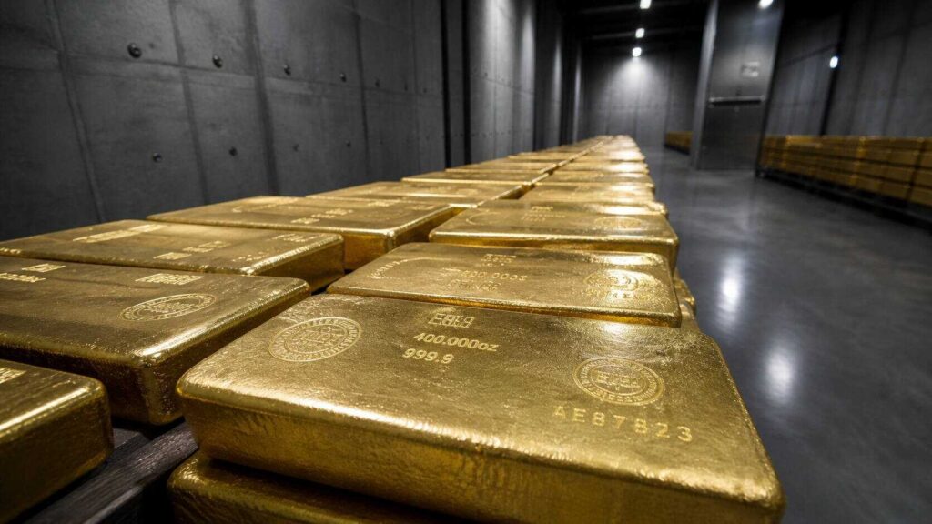 Rows of 400oz gold bars stacked in a central bank vault