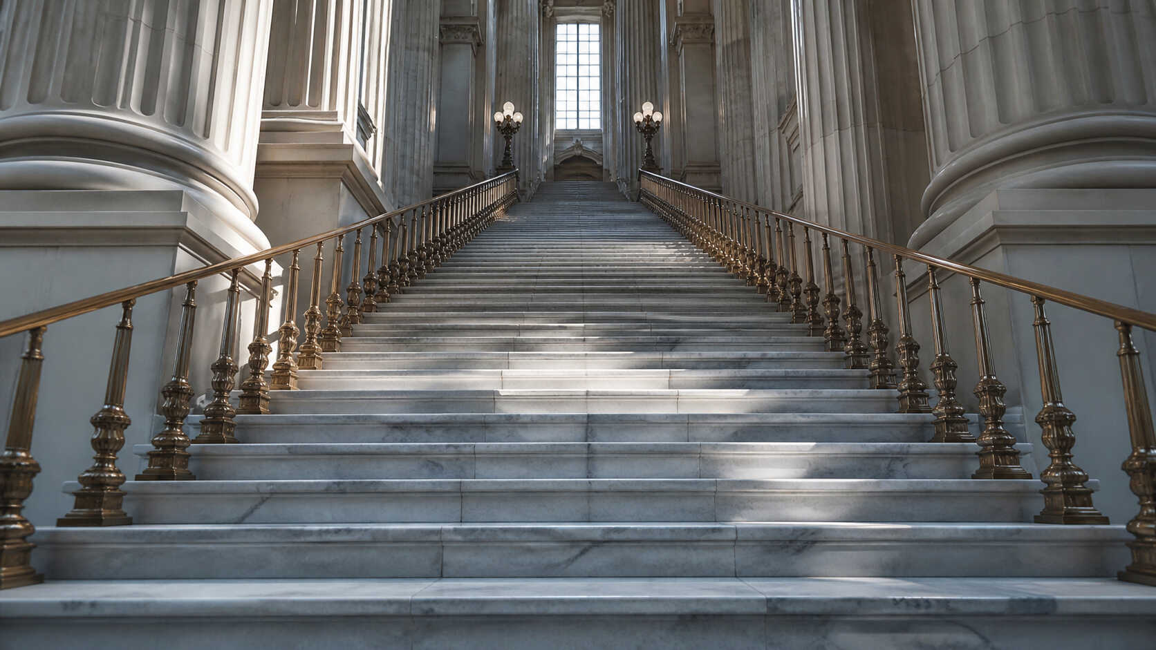 Grand marble staircase with brass railings inside a classical financial institution, viewed from below looking upward
