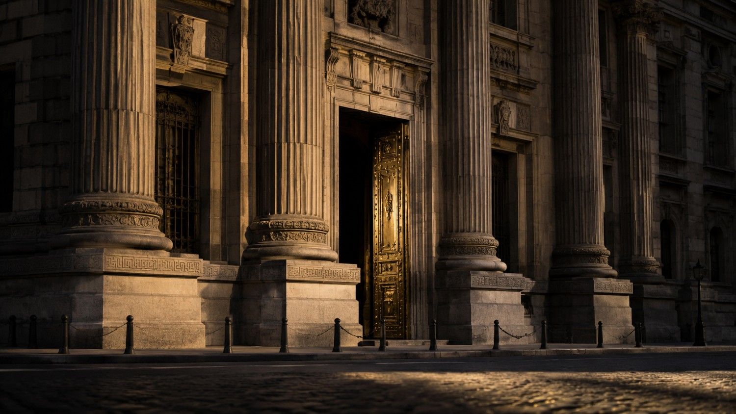 Neoclassical central bank building exterior with ornate gold doors and stone columns at golden hour, representing global gold reserves by country
