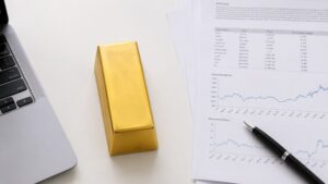 Gold bar beside commodity research report showing gold and silver price charts — Morgan Stanley gold price 2026 outlook analysis