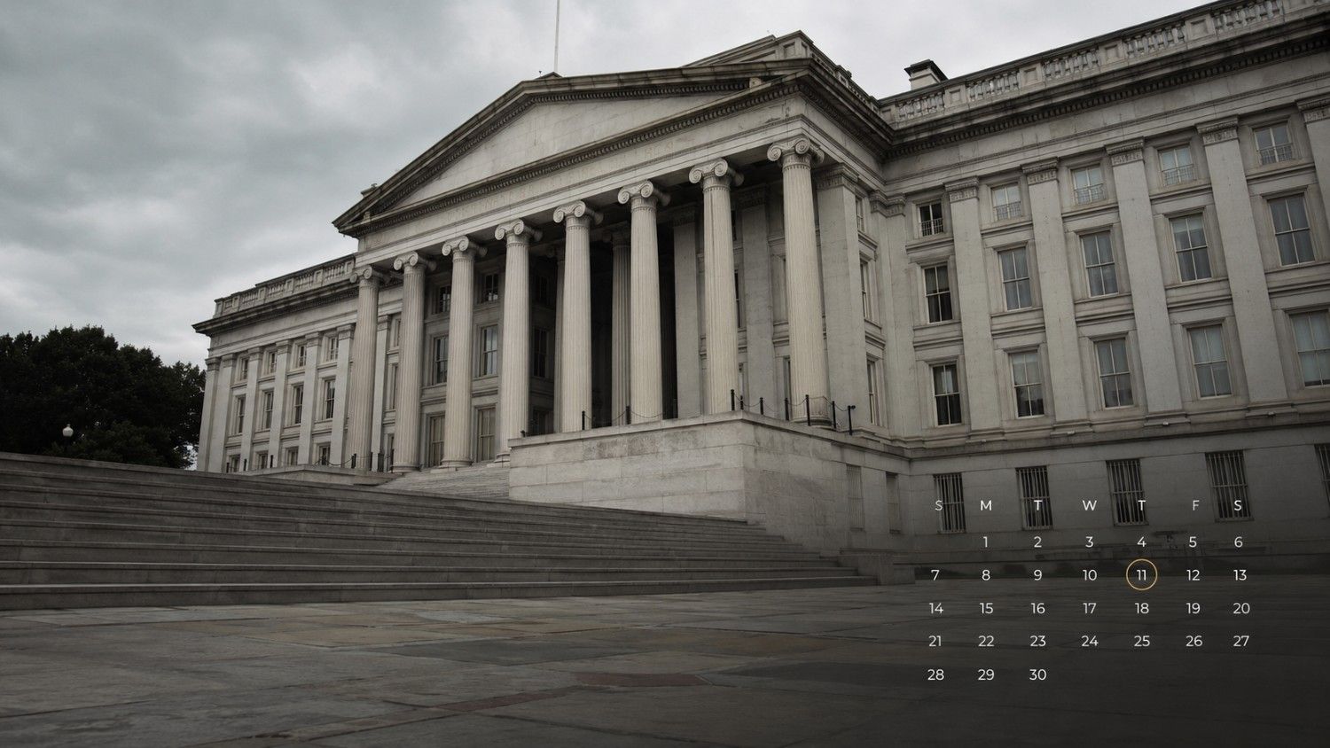 The US Treasury Building in Washington DC photographed from ground level on an overcast day, with broad stone steps in the foreground and neoclassical columns framing the facade — illustrating the federal institution behind PCE inflation data and interest rate policy affecting gold prices.