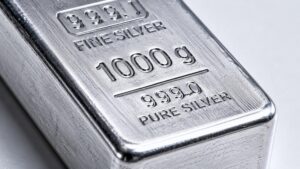 Close-up of a 1000g 999.0 pure silver bullion bar with brushed metal surface and stamped engravings, illustrating the gold silver ratio analysis and silver's structural position in the 2026 precious metals market