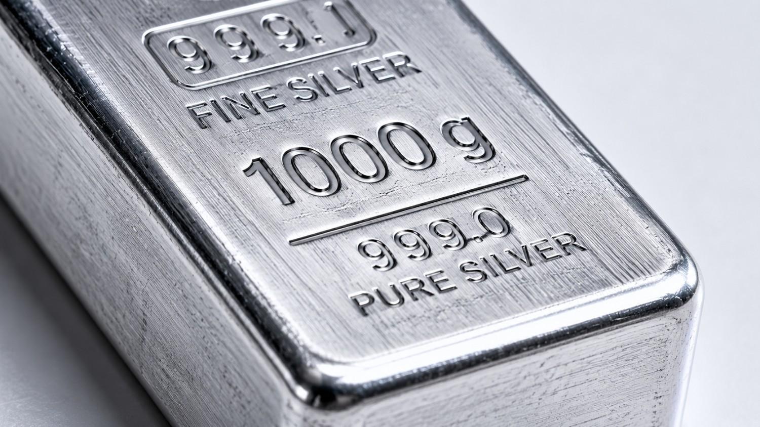Close-up of a 1000g 999.0 pure silver bullion bar with brushed metal surface and stamped engravings, illustrating the gold silver ratio analysis and silver's structural position in the 2026 precious metals market