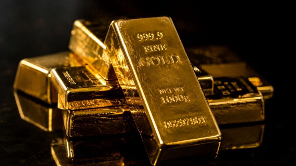 Gold bullion bars stamped 999.9 Fine Gold 1000g on a dark reflective surface — physical gold as a store of value