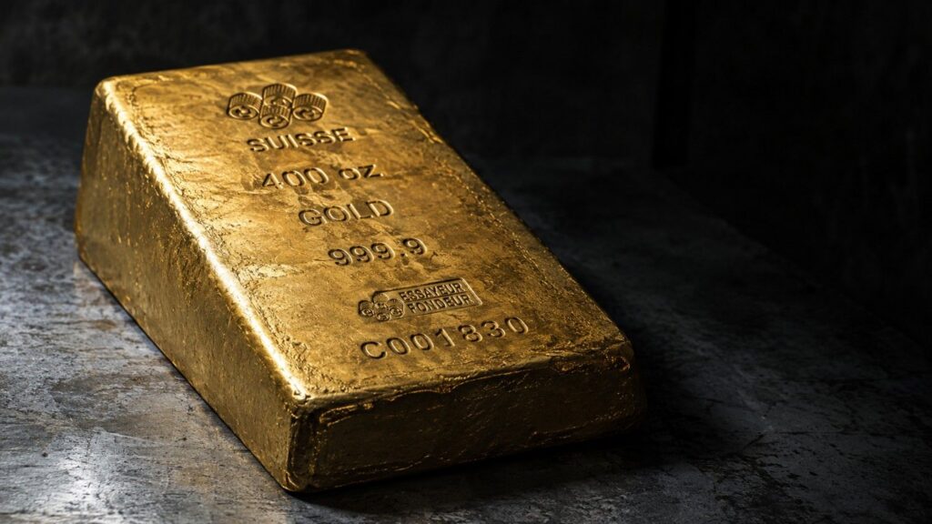 A 400 troy ounce LBMA Good Delivery gold bar stamped 999.9 fine gold, resting on a vault floor — the institutional weight standard that underpins every troy ounce price quote in global precious metals markets.