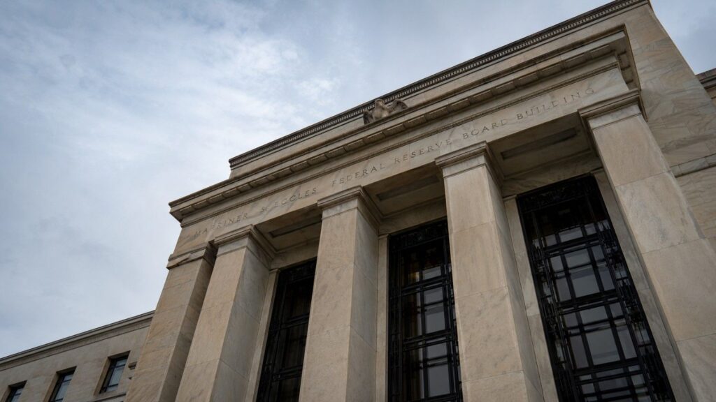 Marriner S. Eccles Federal Reserve Board Building in Washington D.C., low-angle exterior shot showing neoclassical columns and stone facade, fed rate hike odds context
