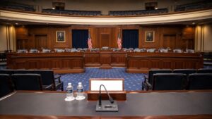 Empty congressional hearing room awaiting Fed Chair Warsh testimony on gold price impact of June CPI and July 2026 rate decision