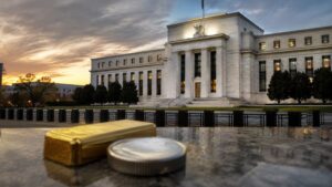 Federal Reserve building with gold bar and silver coin — FOMC minutes July 2026 impact on gold and silver prices