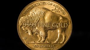 American Gold Buffalo coin reverse showing .9999 fine gold inscription, bison relief, and 50 dollars 1 oz denomination on black background