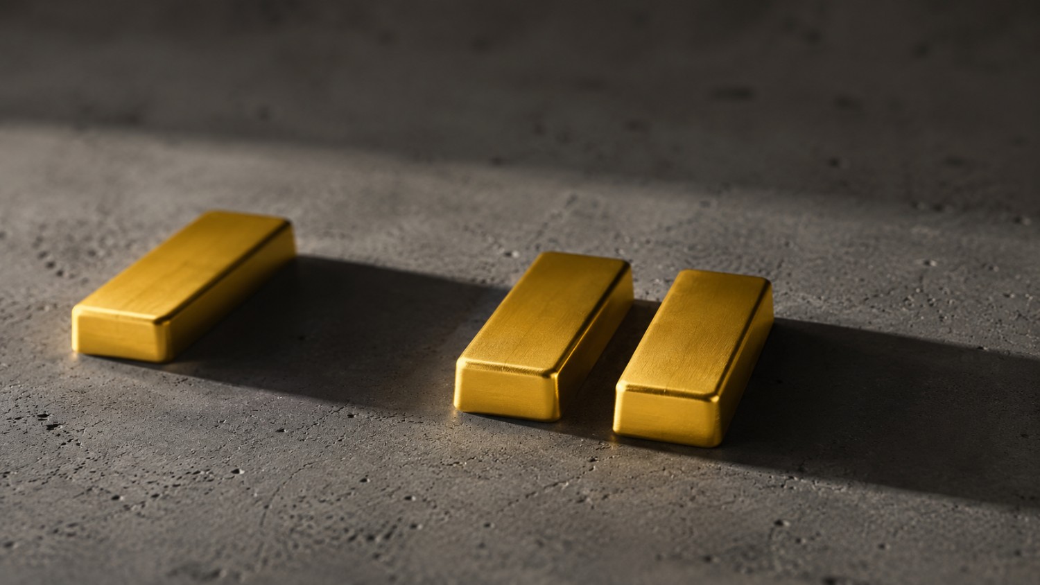 Three gold bars on grey concrete with the spacing between them narrowing, illustrating the shrinking interval behind the national debt and gold story.