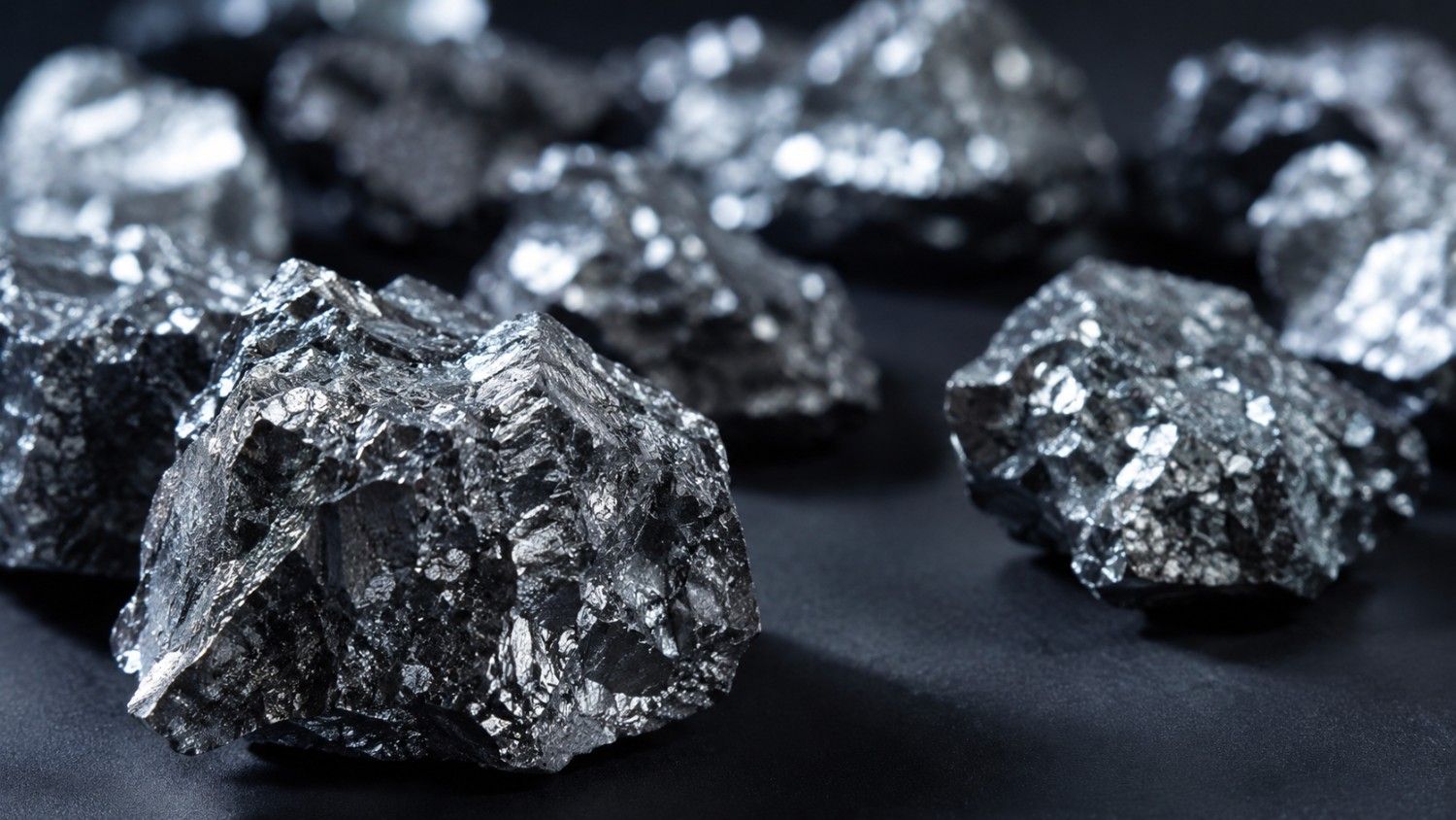 Raw polysilicon chunks on a dark surface — the upstream material at the center of Trump's polysilicon tariff and its implications for silver demand